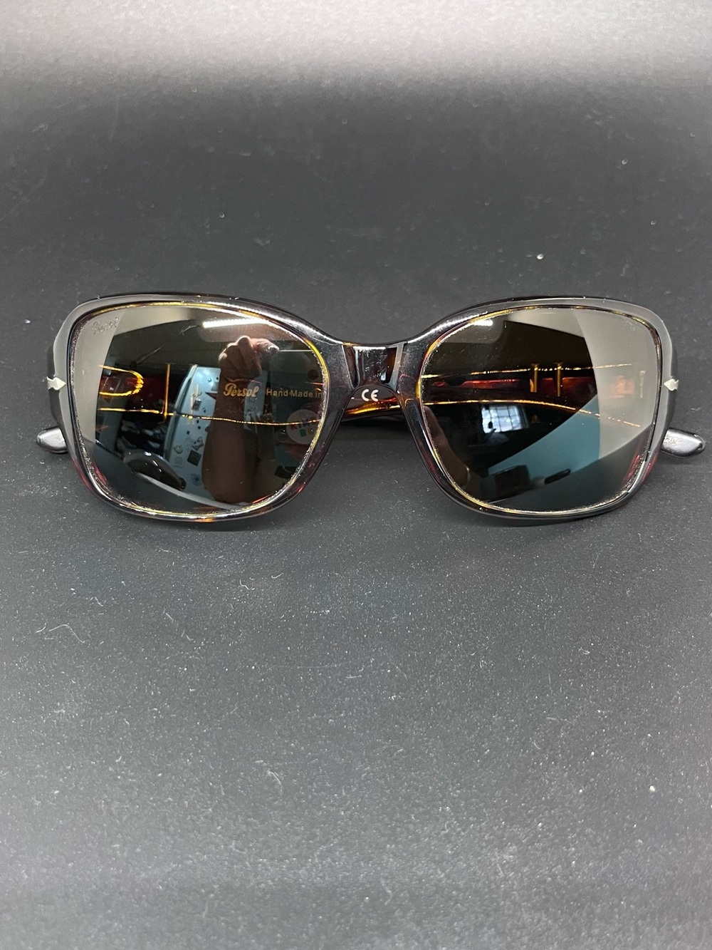 Women’s Persol sunglasses with amber lenses and tortoises frames